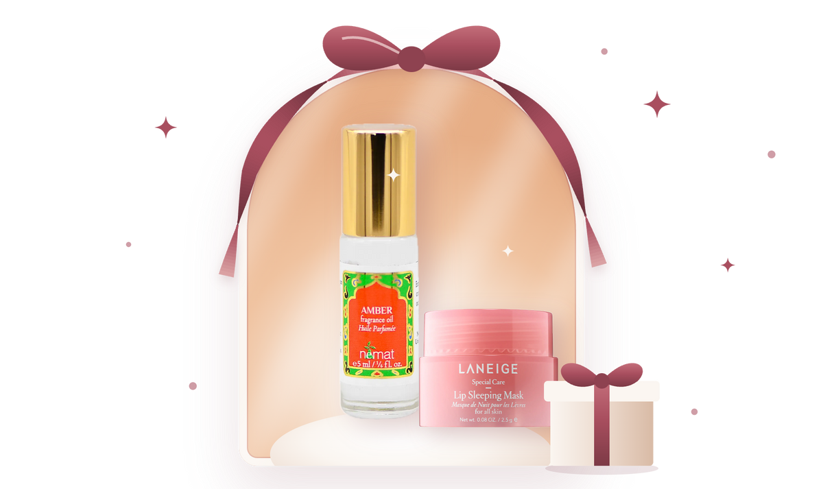 Nemat Amber oil mini and Laneige Lip Sleeping Mask mini in a ribbon-tied arch window with a small gift box