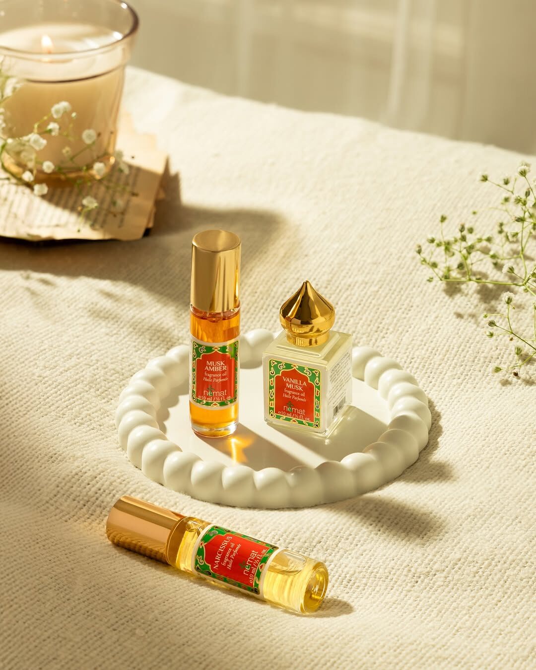 Nemat Musk Amber and Vanilla Musk perfume oil minis on a ceramic tray