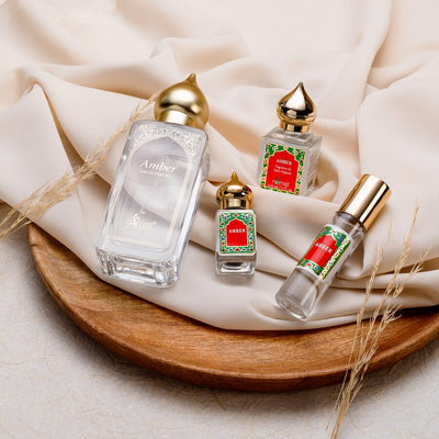 Nemat Amber eau de parfum with three Amber perfume oil minis on a wooden tray